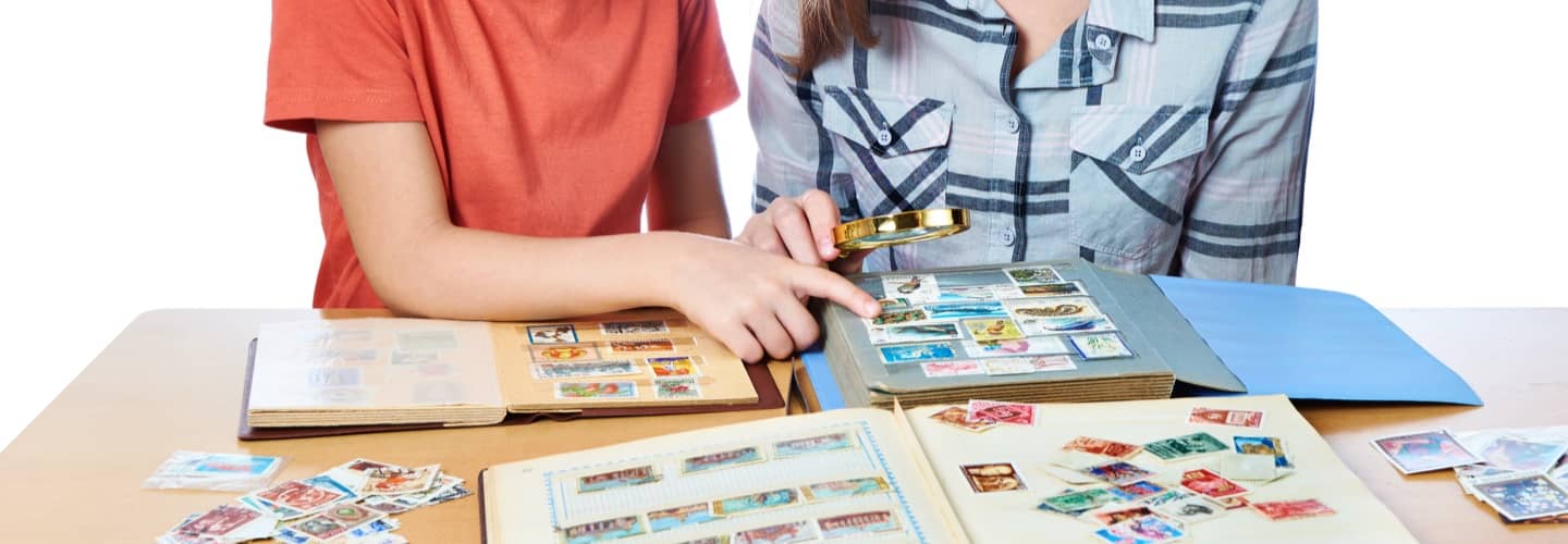 Young collectors looking through stamp albums