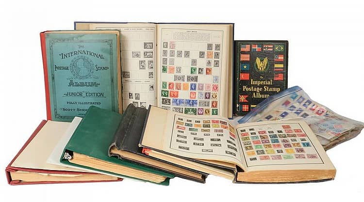 Several inherited stamp albums open to pages of stamps